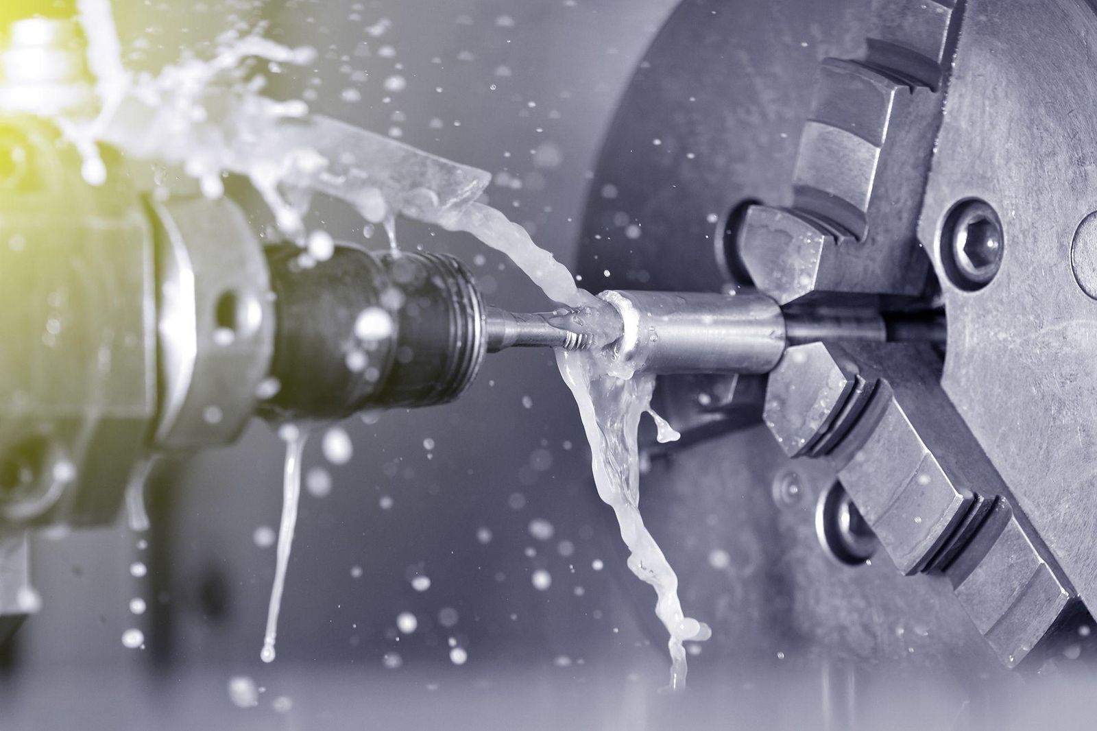 A CNC machine tool cutting metal with coolant spray